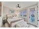 Comfortable bedroom featuring a king bed, modern lighting, and access to a balcony with stunning views at 4357 Marina View Way, Cortez, FL 34215