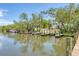 Scenic view of a wooden boat dock with lush trees and waterway views during daylight hours at 4357 Marina View Way, Cortez, FL 34215