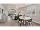Inviting dining area featuring modern furniture, an elegant chandelier, and abundant natural light with scenic window views at 4357 Marina View Way, Cortez, FL 34215