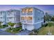 Beautiful two-story home featuring dual balconies, well-kept landscaping, and a paved driveway leading to a garage at 4357 Marina View Way, Cortez, FL 34215