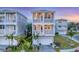 Charming two-story home with dual balconies, lush landscaping, and a paved driveway leading to the garage at 4357 Marina View Way, Cortez, FL 34215