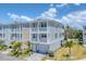 Beautiful two-story home with dual balconies, well-kept landscaping, and a paved driveway leading to a garage at 4357 Marina View Way, Cortez, FL 34215