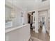 Bright hallway with closet, a decorative chandelier, and natural light from a window at 4357 Marina View Way, Cortez, FL 34215