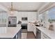 Bright and modern kitchen featuring stainless steel appliances, white cabinets, and a functional layout for easy cooking at 4357 Marina View Way, Cortez, FL 34215