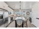 Modern kitchen boasts stainless steel appliances, a center island, and sleek white cabinetry, ideal for culinary enthusiasts at 4357 Marina View Way, Cortez, FL 34215