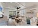 Bright living room with beamed ceilings, fan, and sliding glass door to the porch at 4357 Marina View Way, Cortez, FL 34215