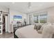 Bright main bedroom with a ceiling fan, television, and view of the outside from the window at 4357 Marina View Way, Cortez, FL 34215