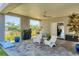 Outdoor patio with ceiling fan, grill, cornhole game, and modern patio furniture at 4357 Marina View Way, Cortez, FL 34215