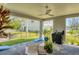 Covered patio with outdoor seating, lush landscaping, and a grill at 4357 Marina View Way, Cortez, FL 34215