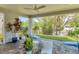 Covered patio with outdoor seating, lush landscaping, and a view of the water at 4357 Marina View Way, Cortez, FL 34215