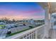 Balcony view overlooking community parking, showing a colorful sky and a glimpse of the bay at 4357 Marina View Way, Cortez, FL 34215