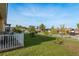Landscaped backyard with lush lawn, trees, and white picket fence at 4605 Casswell Dr, New Port Richey, FL 34652