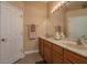 Bathroom featuring a double sink vanity, a large mirror, and neutral decor, perfect for everyday living at 4605 Casswell Dr, New Port Richey, FL 34652