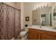 Well-lit bathroom featuring a vanity, commode and bathtub with curtain at 4605 Casswell Dr, New Port Richey, FL 34652