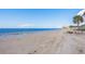 Wide sandy beach with calm blue waters and distant skyline at 4605 Casswell Dr, New Port Richey, FL 34652