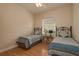 Bedroom with a window, ceiling fan and two beds with matching decor at 4605 Casswell Dr, New Port Richey, FL 34652