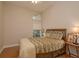 Bright bedroom with wooden floors, ceiling fan and a decorative window above the standard window at 4605 Casswell Dr, New Port Richey, FL 34652