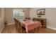 Formal dining room with hardwood floors, chandelier, and a window view, perfect for Gathering gatherings and entertaining at 4605 Casswell Dr, New Port Richey, FL 34652