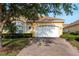 Charming yellow home with a brick driveway, well-kept lawn and beautiful landscaping at 4605 Casswell Dr, New Port Richey, FL 34652