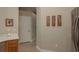 Hallway with neutral walls, tile flooring, and framed artwork connecting the kitchen and other areas of the home at 4605 Casswell Dr, New Port Richey, FL 34652