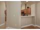 Modern kitchen view showcasing wood cabinetry, a peninsula with seating, and great countertop space at 4605 Casswell Dr, New Port Richey, FL 34652