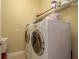 Bright laundry room with modern washer and dryer, shelving and storage space at 4605 Casswell Dr, New Port Richey, FL 34652