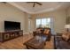 Spacious living room featuring hardwood floors, a large TV, and comfortable sofas at 4605 Casswell Dr, New Port Richey, FL 34652