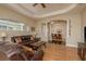 Open-concept living room featuring hardwood floors, an archway and comfortable sofas at 4605 Casswell Dr, New Port Richey, FL 34652