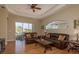 Comfortable living room with a ceiling fan, hardwood floors and a large sliding glass door at 4605 Casswell Dr, New Port Richey, FL 34652