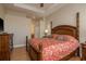 Main bedroom with a king-sized bed, tray ceilings, a ceiling fan, and an en-suite bathroom at 4605 Casswell Dr, New Port Richey, FL 34652