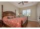 Main bedroom featuring a tray ceiling, ceiling fan, a decorative bed, and a window view at 4605 Casswell Dr, New Port Richey, FL 34652