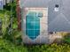Aerial view showcasing a private screened-in pool and spa amidst lush landscaping, offering an exclusive outdoor retreat at 4612 River Overlook Dr, Valrico, FL 33596