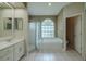 Bright bathroom featuring double vanity, soaking tub, and walk-in shower at 4612 River Overlook Dr, Valrico, FL 33596
