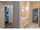 Bathroom with double sinks, tiled floors, and doorways leading to a bedroom and living room at 4612 River Overlook Dr, Valrico, FL 33596