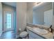 Bathroom features a sink with marble countertop, toilet, and doorway to the backyard at 4612 River Overlook Dr, Valrico, FL 33596