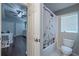 Bathroom featuring a shower-tub combo with cat-themed shower curtain, tile floors, and views of the bedroom at 4612 River Overlook Dr, Valrico, FL 33596