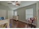 Cozy bedroom with hardwood floors, ceiling fan, and natural light from the window at 4612 River Overlook Dr, Valrico, FL 33596