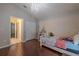 Bedroom with hardwood floors, closet doors, and doorways leading to the hallway and bedroom at 4612 River Overlook Dr, Valrico, FL 33596