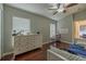 Bright bedroom featuring hardwood floors, large windows, and neutral wall paint at 4612 River Overlook Dr, Valrico, FL 33596