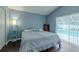 This bedroom features hard wood floors, a ceiling fan, and access to a pool outside at 4612 River Overlook Dr, Valrico, FL 33596