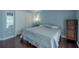 This bedroom features hard wood floors, a ceiling fan, and a bright blue wall at 4612 River Overlook Dr, Valrico, FL 33596