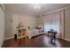 Bedroom features hardwood floors, a ceiling light fixture, and a window with curtains at 4612 River Overlook Dr, Valrico, FL 33596