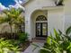 Welcoming front entrance with elegant double doors, arched window, and mature landscaping at 4612 River Overlook Dr, Valrico, FL 33596