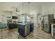 Open floor plan featuring kitchen island, stainless steel appliances, and living area with fireplace at 4612 River Overlook Dr, Valrico, FL 33596
