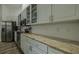 Kitchen featuring granite countertops, stainless steel appliances, and white cabinets at 4612 River Overlook Dr, Valrico, FL 33596