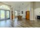 Open-concept living area with hardwood floors, dining area, and view of the front entrance at 4612 River Overlook Dr, Valrico, FL 33596