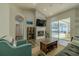 Bright living room with a fireplace, modern furniture, and sliding glass doors to the pool area at 4612 River Overlook Dr, Valrico, FL 33596