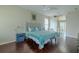 Comfortable main bedroom boasts hardwood floors, a ceiling fan, and a view of the en suite bathroom at 4612 River Overlook Dr, Valrico, FL 33596