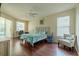 Light-filled main bedroom with access to the pool and a comfortable seating area at 4612 River Overlook Dr, Valrico, FL 33596