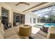 Inviting covered patio with comfortable seating and view of the pool and spa at 4612 River Overlook Dr, Valrico, FL 33596